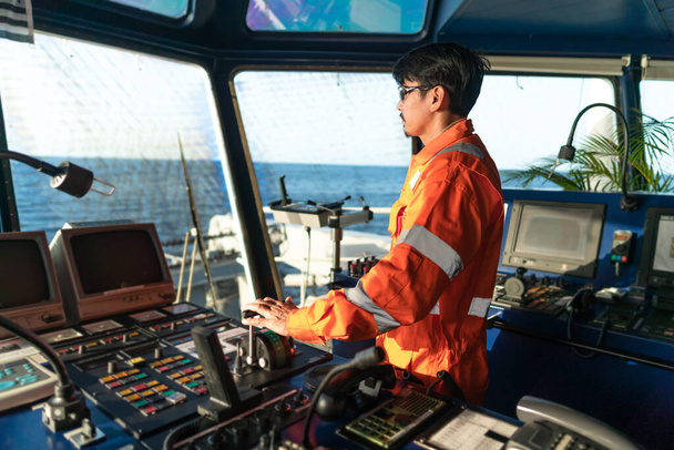 Filipiński oficer pokładowy na mostku statku lub statku. Mówi w radiu GMDSS VHF - Zdjęcie, obraz