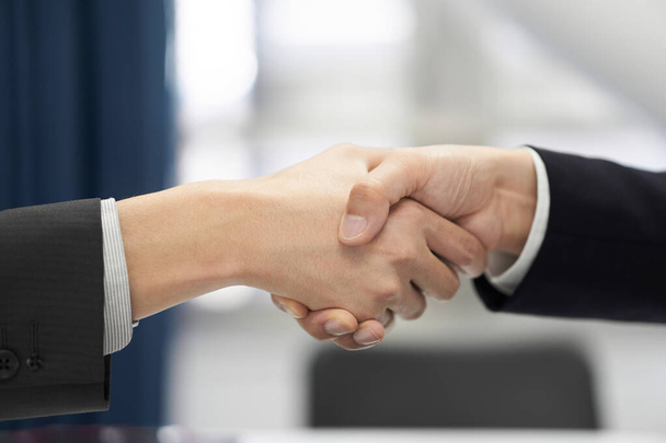 A Japanese male businessman shakes the hand of a contract - Photo, Image