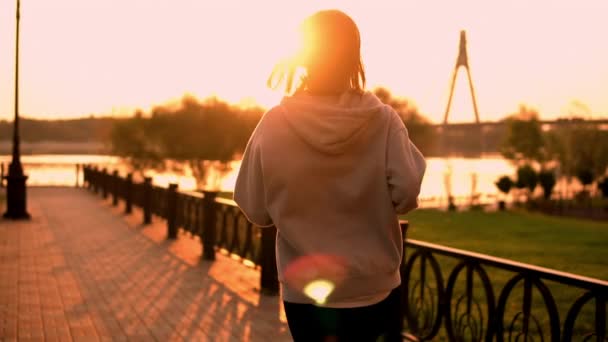 unrecognizable female running at sunset - Filmati, video
