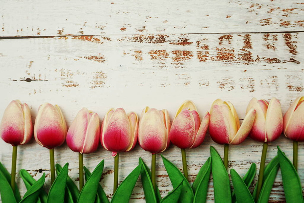 Pink Tulips bouquet with Space for text on a wooden background - Photo, image