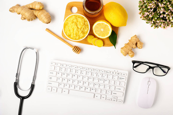 Natural medicine. The workspace of a blogger medic. Immunostimulating products: lemon, honey, ginger root. - Photo, Image