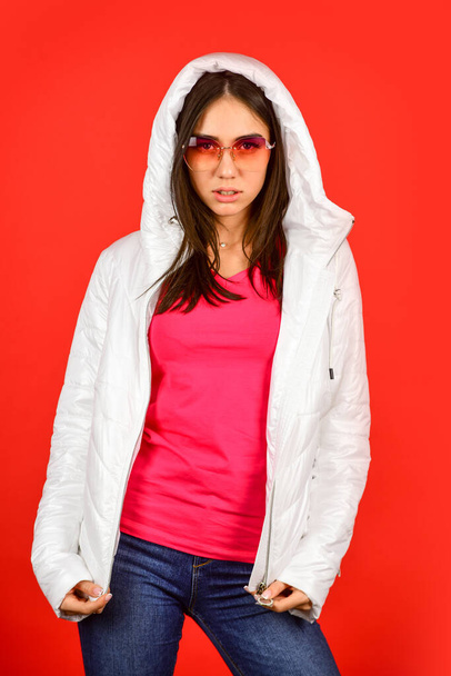 Woman fashion model. Fashion outfit. Pink eyeglasses. Keep calm and wear cool glasses. Cute Pretty girl hood jacket red background. Fashion has to reflect who you are. Woman enjoy spring weather - Photo, image