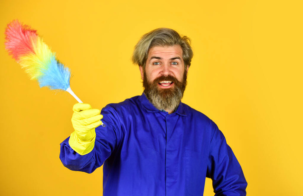 Husband cleaning home. Polypropylene duster. Hipster hold cleaning tool. Cleaning concept. Small duster. Cleaning service. Housekeeping duties. Cleaning apartment. Man use pp duster. Dust allergy - Φωτογραφία, εικόνα