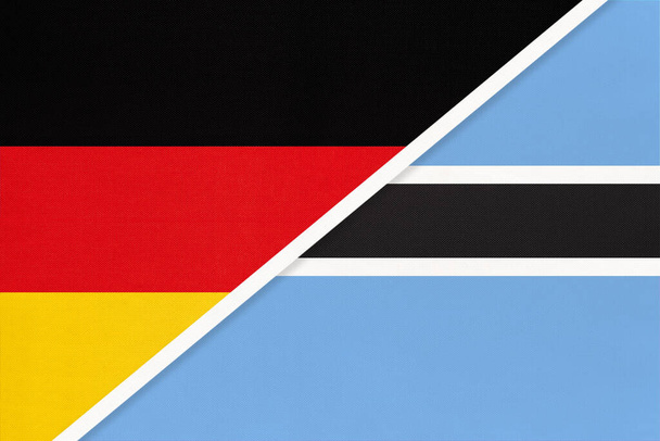 Bundesrepublik Deutschland gegen Botswana, Symbol zweier Nationalflaggen aus Textil. Beziehungen, Partnerschaft und Meisterschaft zwischen europäischen und afrikanischen Ländern. - Foto, Bild