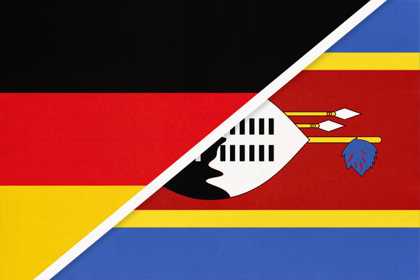 Republika Federalna Niemiec przeciwko Królestwu Eswatini lub Suazi, symbolowi dwóch flag narodowych z sektora tekstylnego. Stosunki, partnerstwo i mistrzostwa między krajami europejskimi i afrykańskimi. - Zdjęcie, obraz