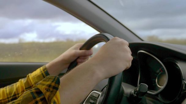 closeup. hands of a man driving a car while driving - 写真・画像