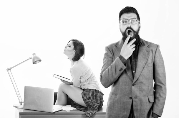 Training in business education. Blurred hipster with open mouth in foreground and pretty teacher in school for adult education. Sexy education worker and bearded man. Providing education and training - Φωτογραφία, εικόνα
