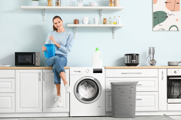 Young woman doing laundry at home - Foto, imagen