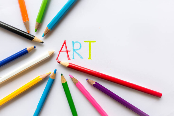 Colorful art pencil layed out on a white paper with the word art written on it. Copyspace. - Photo, Image