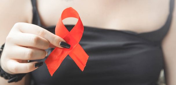 Woman holding red ribbon. Breast cancer - Fotografie, Obrázek