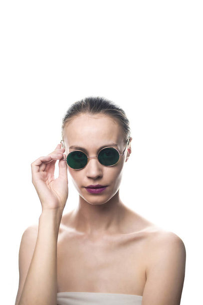Fashion girl model in green sunglasses isolated on white background looking at the camera. Studio shot. - Φωτογραφία, εικόνα