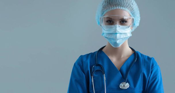 Professional medical worker in protection suit. Nurse, surgeon, doctor or paramedic in blue uniform. Emergency medicine and ambulance concept. - Фото, зображення