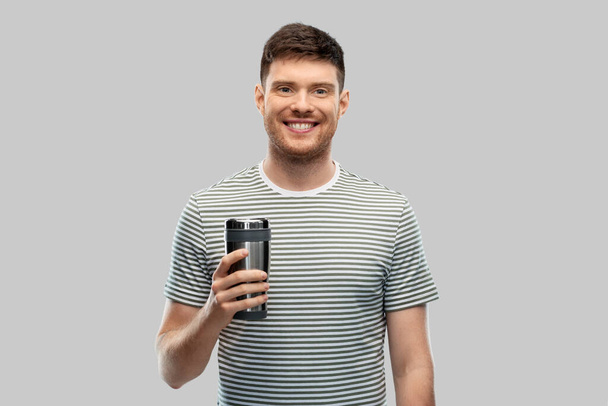 man with thermo cup or tumbler for hot drinks - Photo, image