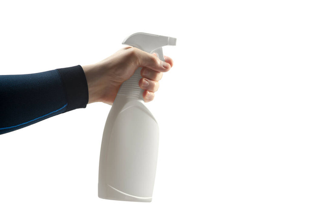 hand holds a pump aerosol sanitizer dispenser sprayer in white plastic bottle with cleanser or antiseptic and spraying, on white background, isolated - Fotó, kép