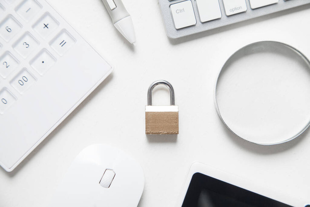 Padlock with business objects. Internet and technology security - 写真・画像