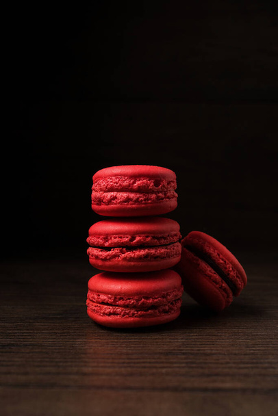 Beautiful colourful desserts. French macaroons on a dark wood background - Foto, Bild