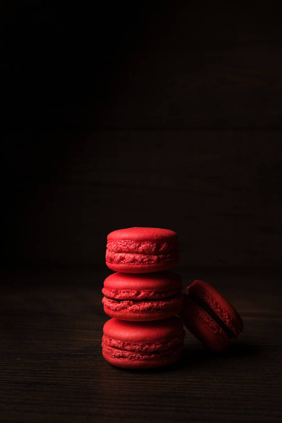 Beautiful colourful desserts. French macaroons on a dark wood background - Foto, imagen