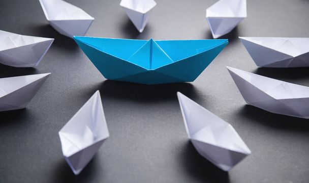 Blue and white paper boat. Leadership concept - Photo, Image