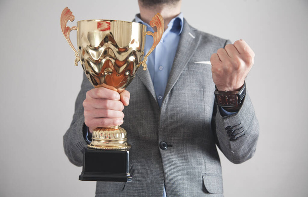 Businessman holding golden trophy. Business, Success - Foto, Imagen