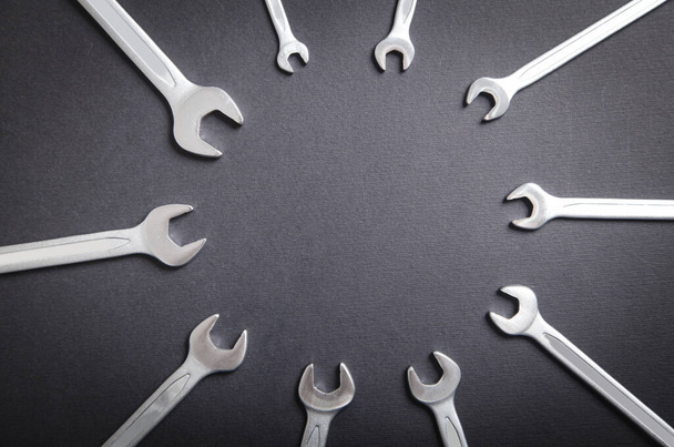 Different sizes wrenches on the black background. - Photo, Image