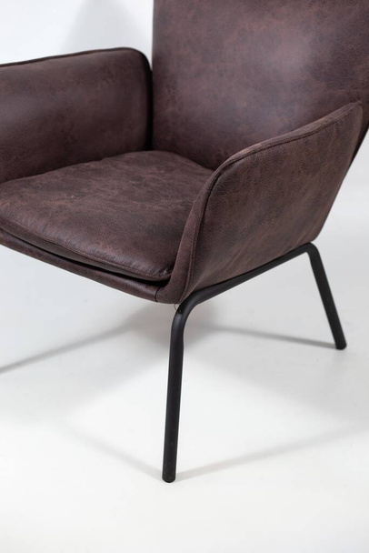 A closeup shot of a dark brown leather armchair - Φωτογραφία, εικόνα