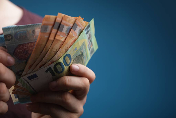 A closeup shot of a man's hand holding euro bills - Фото, изображение