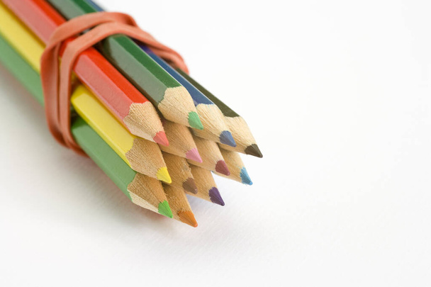 Childs colouring pencils on a plain white textured paper background - Photo, Image