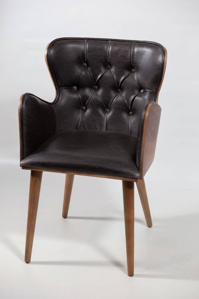 A black leather armchair placed on a white background - Fotó, kép
