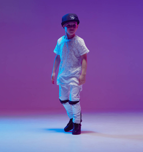 Cool young boy child dancing hip hop in the Studio against the background of neon lights. Break dance poster. - Φωτογραφία, εικόνα