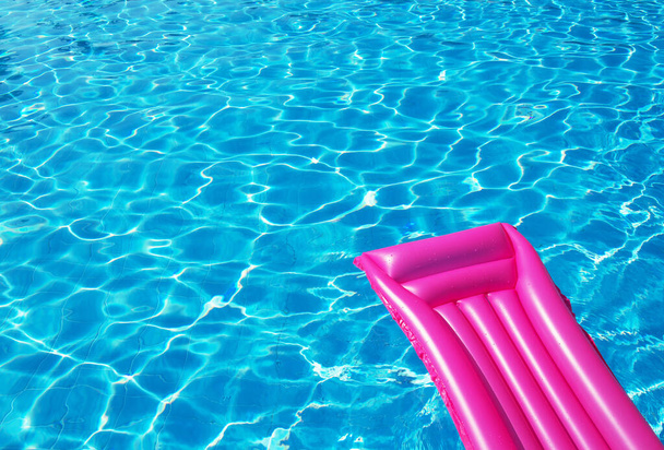 Pink inflatable mattress floating on water surface - Photo, Image