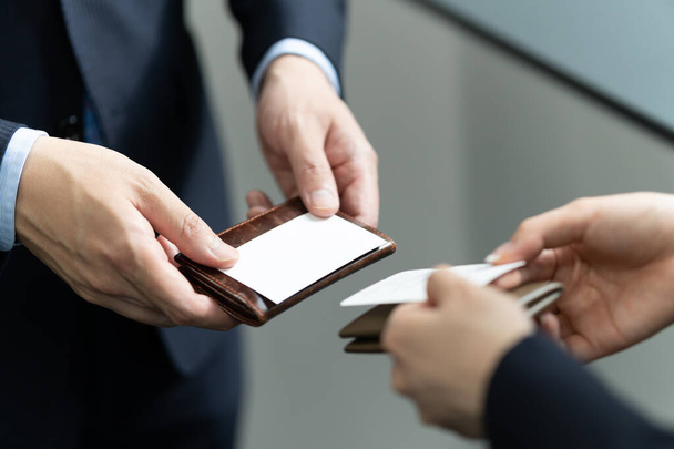 A close-up of a Japanese businessman exchanging business cards - Foto, Imagem