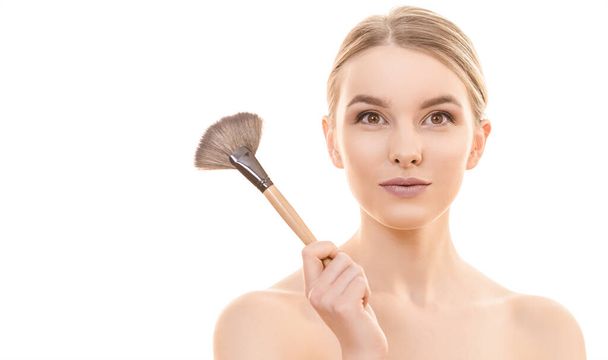 The woman holding a cosmetic brush on the white background - Photo, image