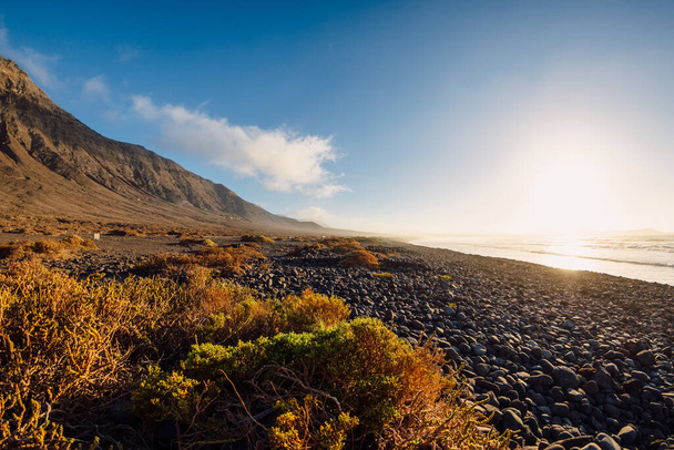 Famara beach, scenic landscape with ocean and mountains in Lanzarote, Canary islands - Fotó, kép