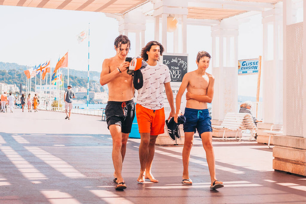 Nice, Provence / France - September 29, 2018: Three young guys on a hot day on the boardwalk - Фото, зображення