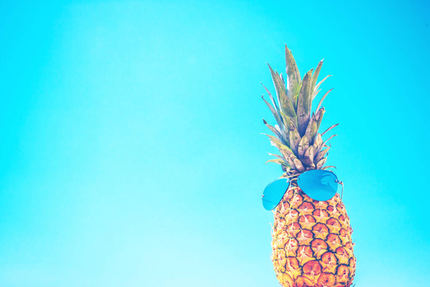 Comical pineapple in sunglasses against the sky - backdrop - Foto, immagini