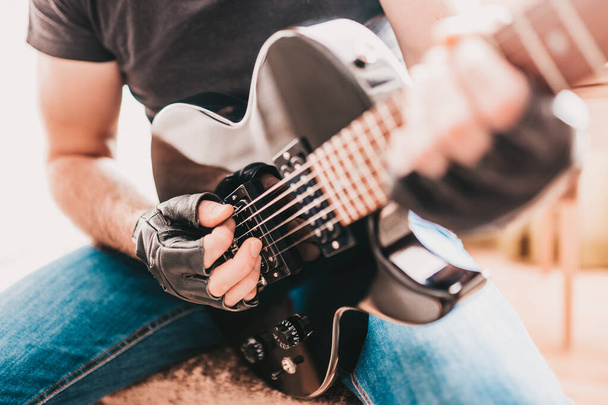 Rocker play heavy metal on electric guitar - Photo, Image