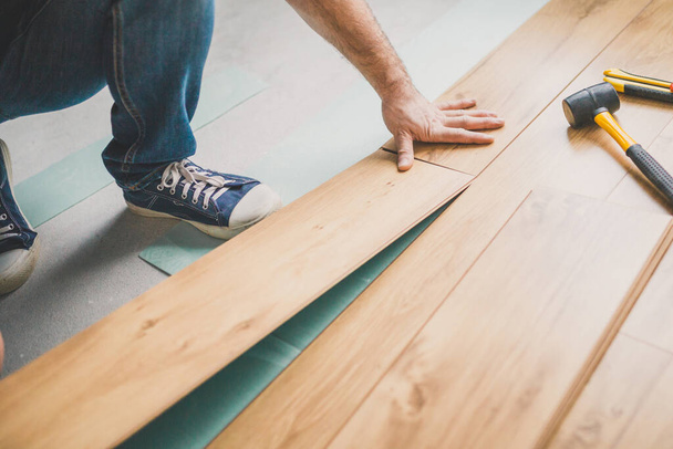 Build a floating floor - flooring - laying laminate - Photo, Image