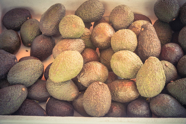 Bunch of Hass avocado in Styrofoam box at local market in Little India, Singapore - Фото, зображення