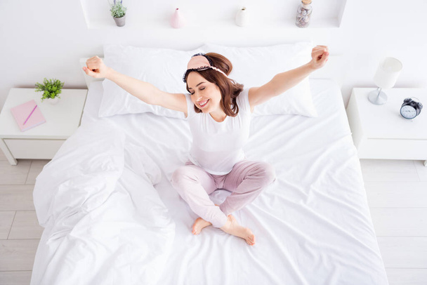 Top above high angle view of her she nice attractive cheerful cheery fresh red haired girl sitting in bed waking up stretching in modern white light interior style room house apartment hotel - Photo, image