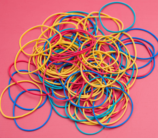 Colored rubber bands for money on a pink background - Photo, Image