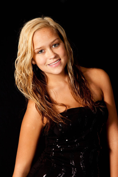 Pretty blond woman in a black dress, with a smile - Photo, Image