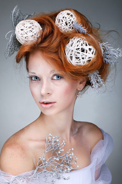 Redheaded girl with new-year decorations in a hair-do. Beautiful New Year and Christmas Tree Holiday Hairstyle and Make up. - Фото, зображення