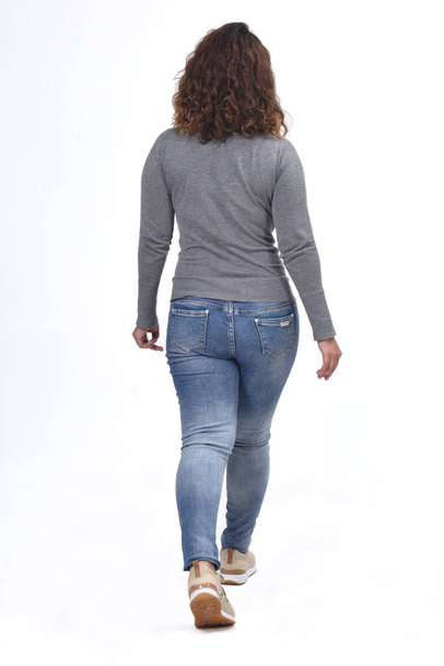 rear view of a woman walking on white - Fotografie, Obrázek