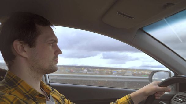 the man behind the wheel of a car while driving on the highway - Valokuva, kuva