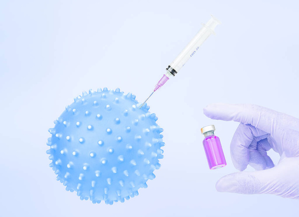 The doctor, nurse or scientist with gloves holding a vaccine. Concept of medicine. Vaccination. Protection. 3d virus image. Horizontal. - Fotoğraf, Görsel