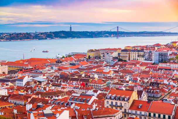 Beautiful panorama of old town Baixa district and Tagus River in Lisbon city during sunset, seen from Sao Jorge Castle hill, Portugal - Fotoğraf, Görsel
