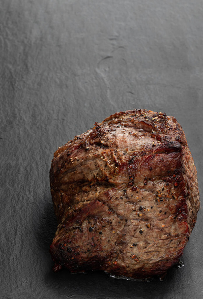 Roast  beef on black stone background  - Foto, Imagen