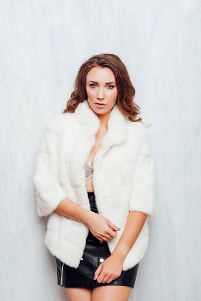 portrait of a beautiful fashionable woman in a white fur coat with hair doves - Fotoğraf, Görsel