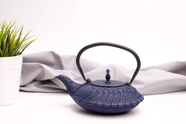 Blue metal cast-iron teapot on a white background. - Foto, afbeelding