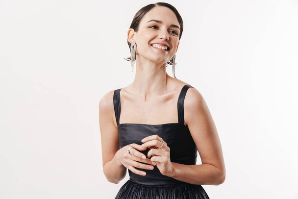 Image of pretty brunette young woman wearing dress smiling at camera isolated over white background - Fotó, kép